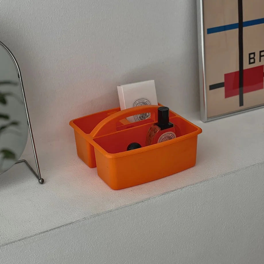 Detailed view of the orange portable caddy with skincare items inside. - RoomDen