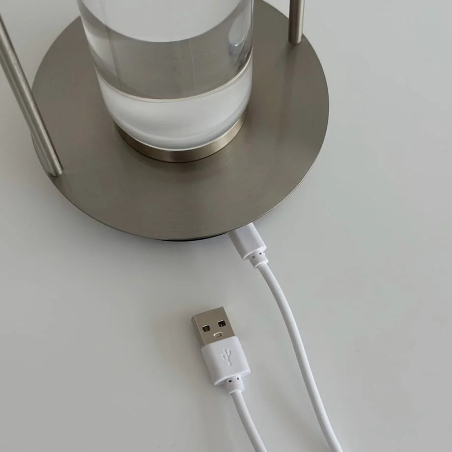 Detail shot of the USB power cable connected to the base of the metal table lamp. - RoomDen