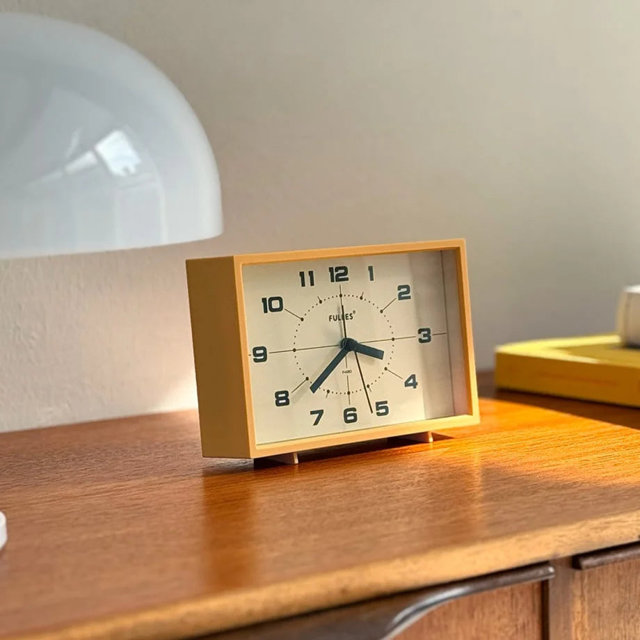 Close-up of the Mustard Yellow Retro Table Clock face showing its analog design.