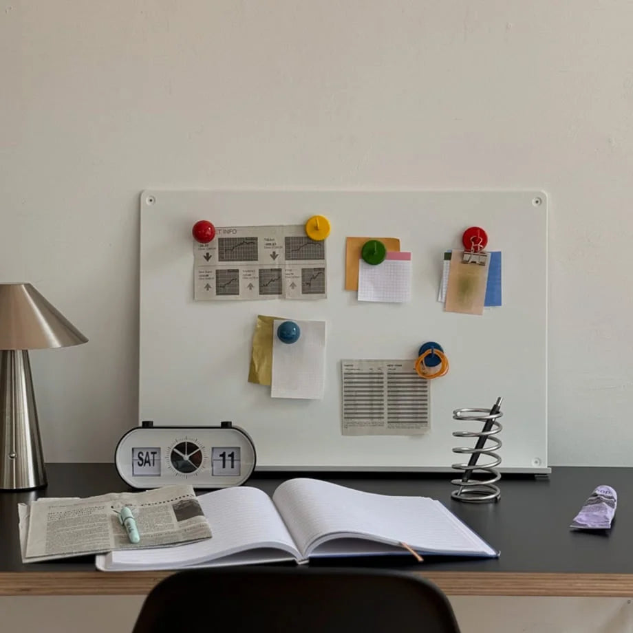 Colorful magnetic hooks used as magnets on a white magnetic board in a stylish desk setup - RoomDen