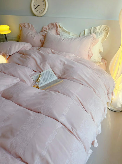 Angled shot of the Blush Pink bedding with an open book, highlighting its dreamy aesthetic. - RoomDen