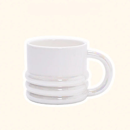 Front view of the chunky ribbed ceramic mug in an iridescent white finish - RoomDen.