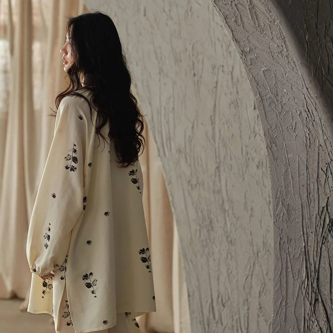 Back view of the model showcasing the drape of the oversized pajama top against a textured archway - RoomDen