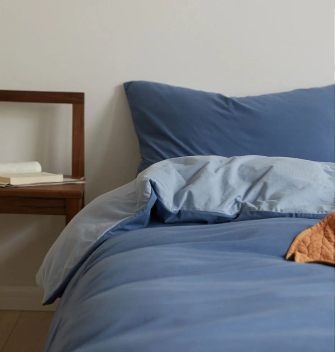 Side View of Denim & Sky Blue Dual-Tone Bedding on Wood Frame Bed - RoomDen