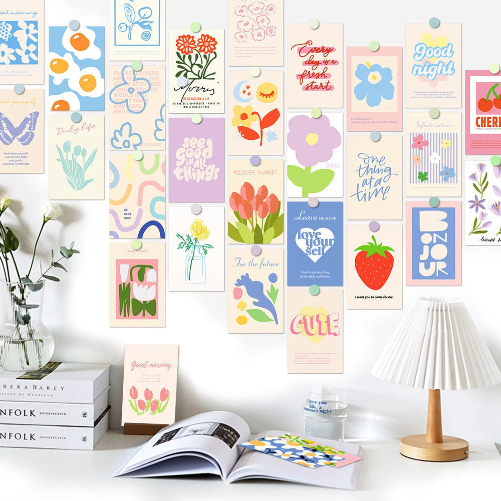 The Vibrant Danish Pastel Wall Collage Kit displayed on a white wall above a clean, organized desk with books and a lamp. - RoomDen
