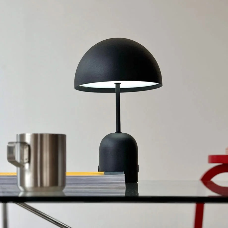 Close-up of the Matte Black mushroom lamp turned on, casting a warm glow - RoomDen