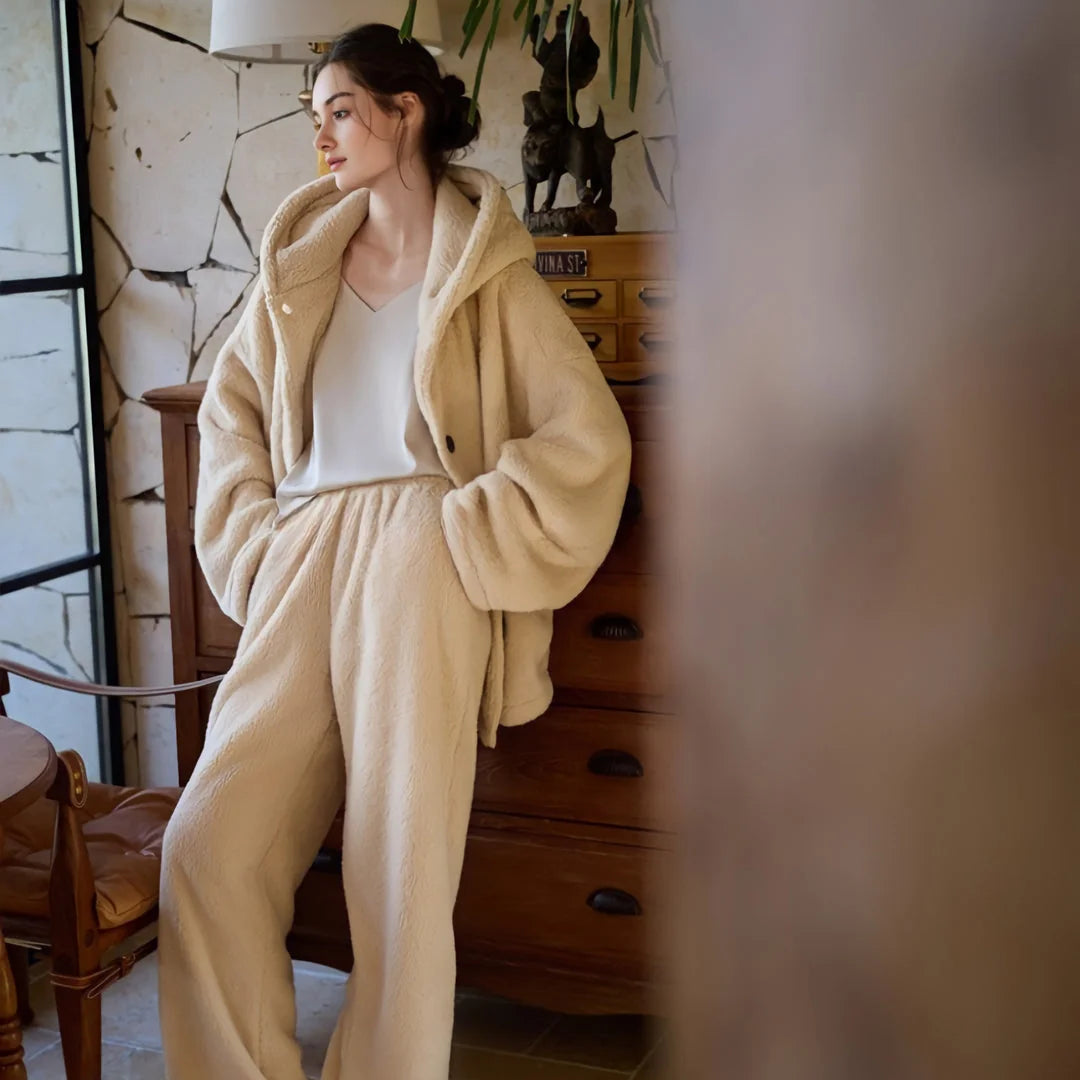 Full body shot of a model in a relaxed pose wearing a two-piece beige fleece loungewear set. - RoomDen