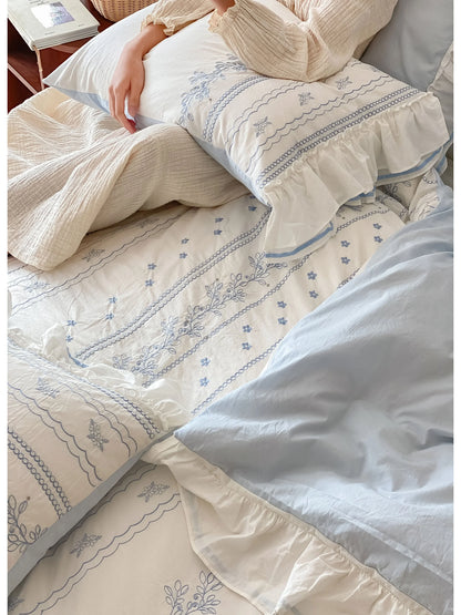 Overhead view showing the texture of the washed cotton and the layers of the Cornflower Blue bedding set.