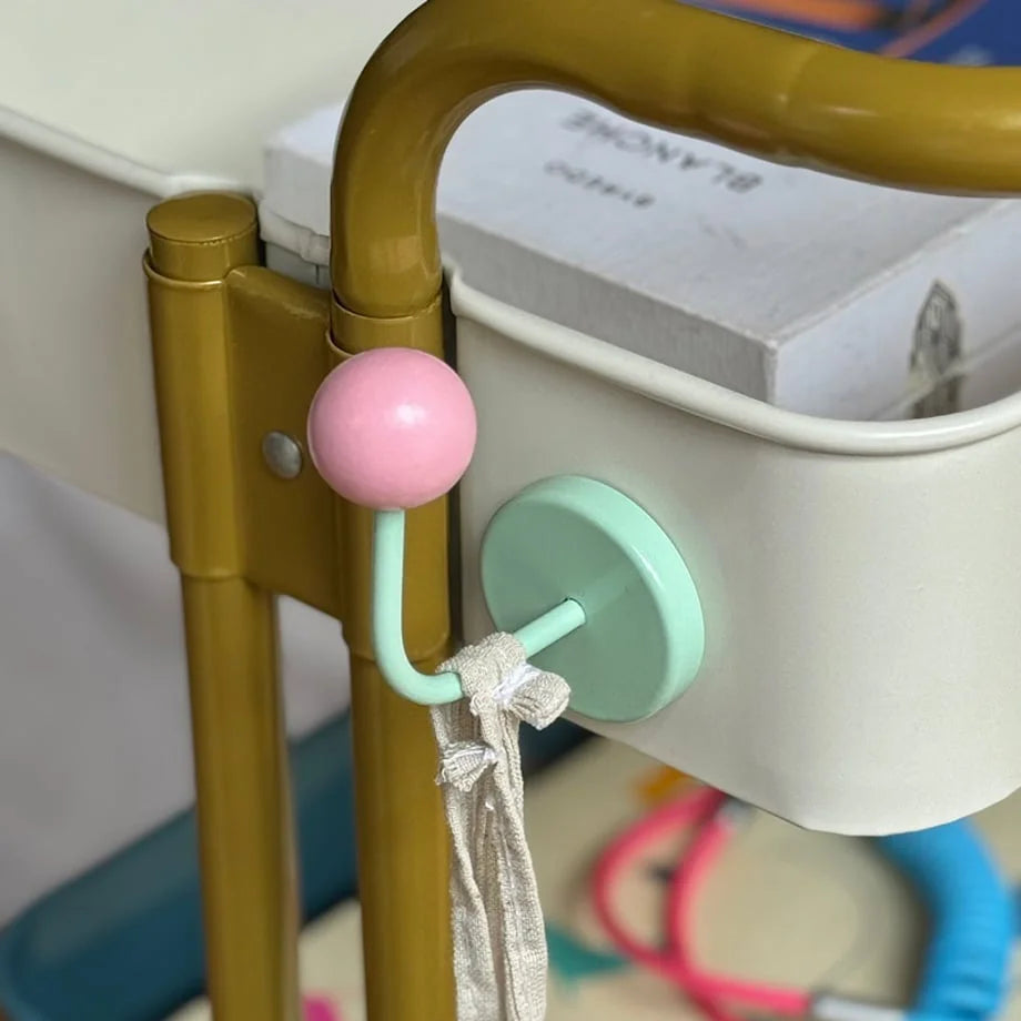 Close-up of the Pink & Mint Metal Hook holding a scrunchie on a white storage cart tier - RoomDen.
