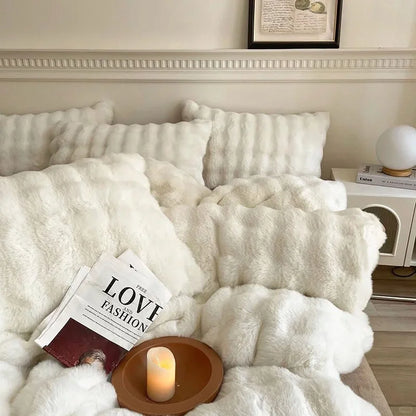 Plush Ruched Flannel Fleece Bedding Set in Cream White, styled with a candle and magazine. - RoomDen