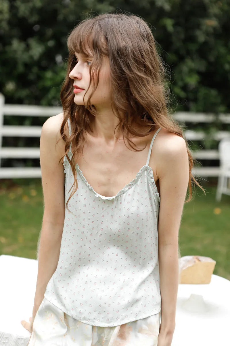 Outdoor lifestyle shot of Sage Green Floral Cami Set in garden setting - RoomDen