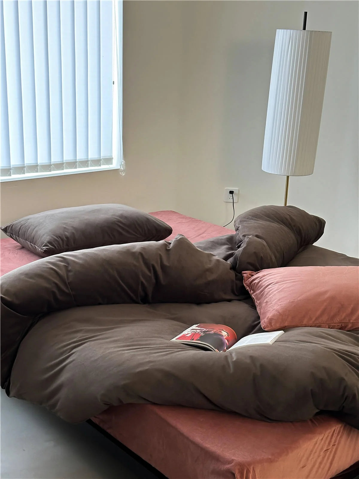 A cozy bed styled with a Mocha Brown velvet duvet cover and a dusty pink sheet and pillow. - RoomDen