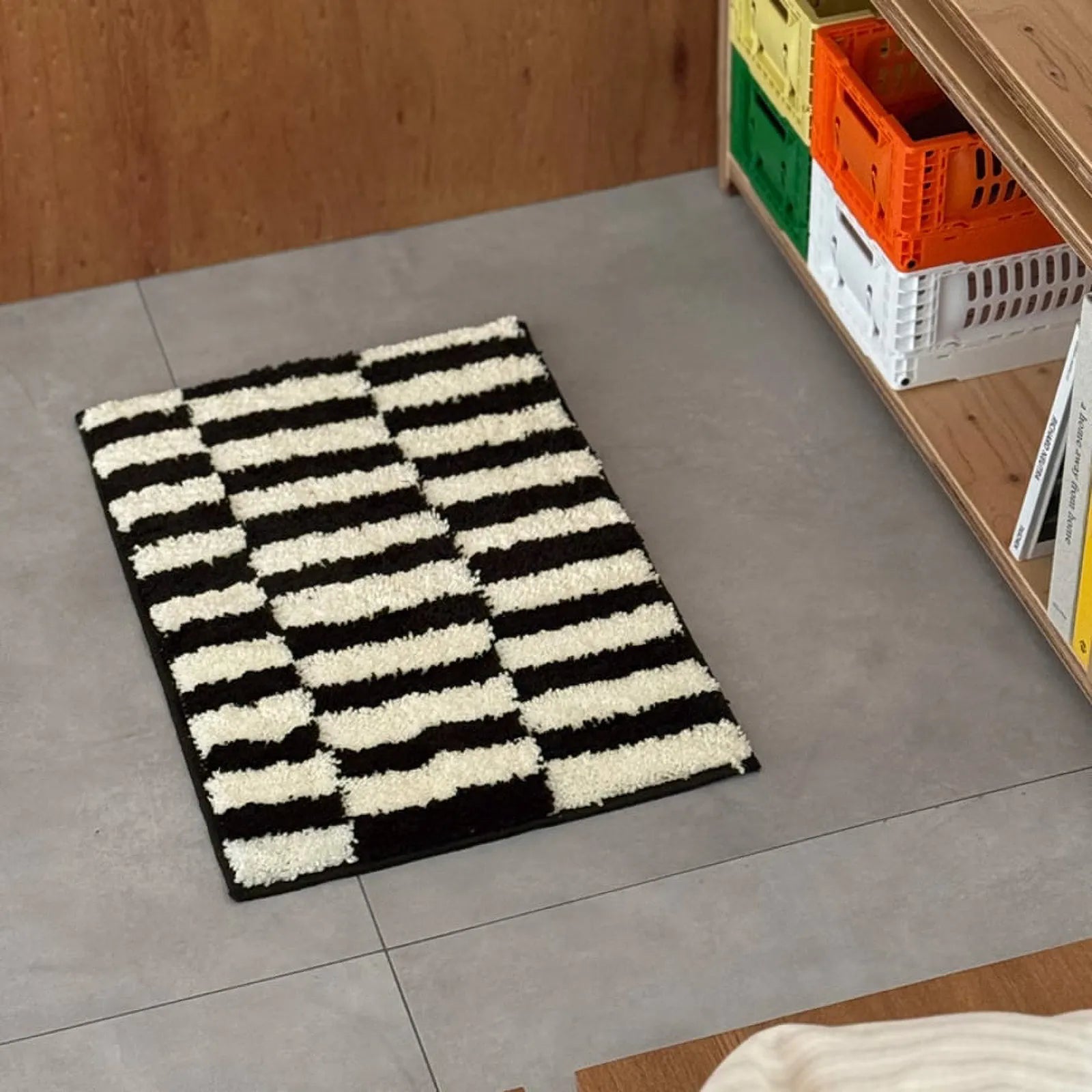 Angle view of the fluffy texture and graphic stripe design of the accent rug near storage crates - RoomDen