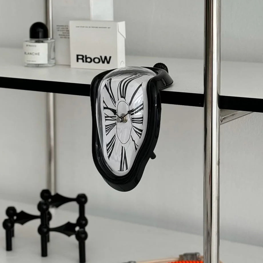 Black Surrealist Melting Clock dripping off a white and chrome shelf. - RoomDen