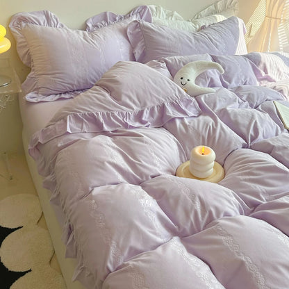 Plush Ruffled Jacquard Velvet Bedding Set in Lavender, styled with a candle and moon plushie. - RoomDen