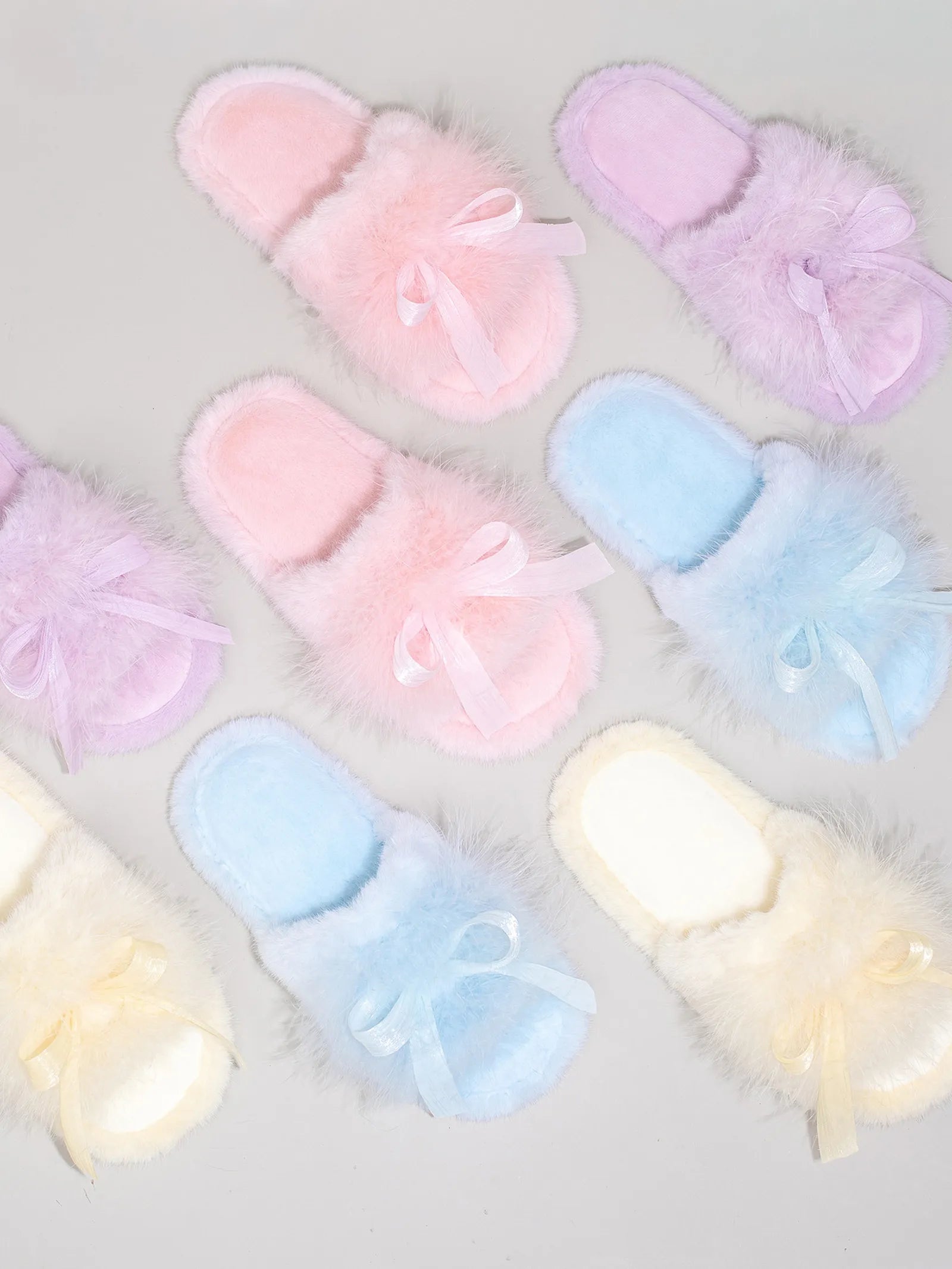 Collection of plush faux fur house slippers in pink, purple, blue, and yellow with satin bows - RoomDen