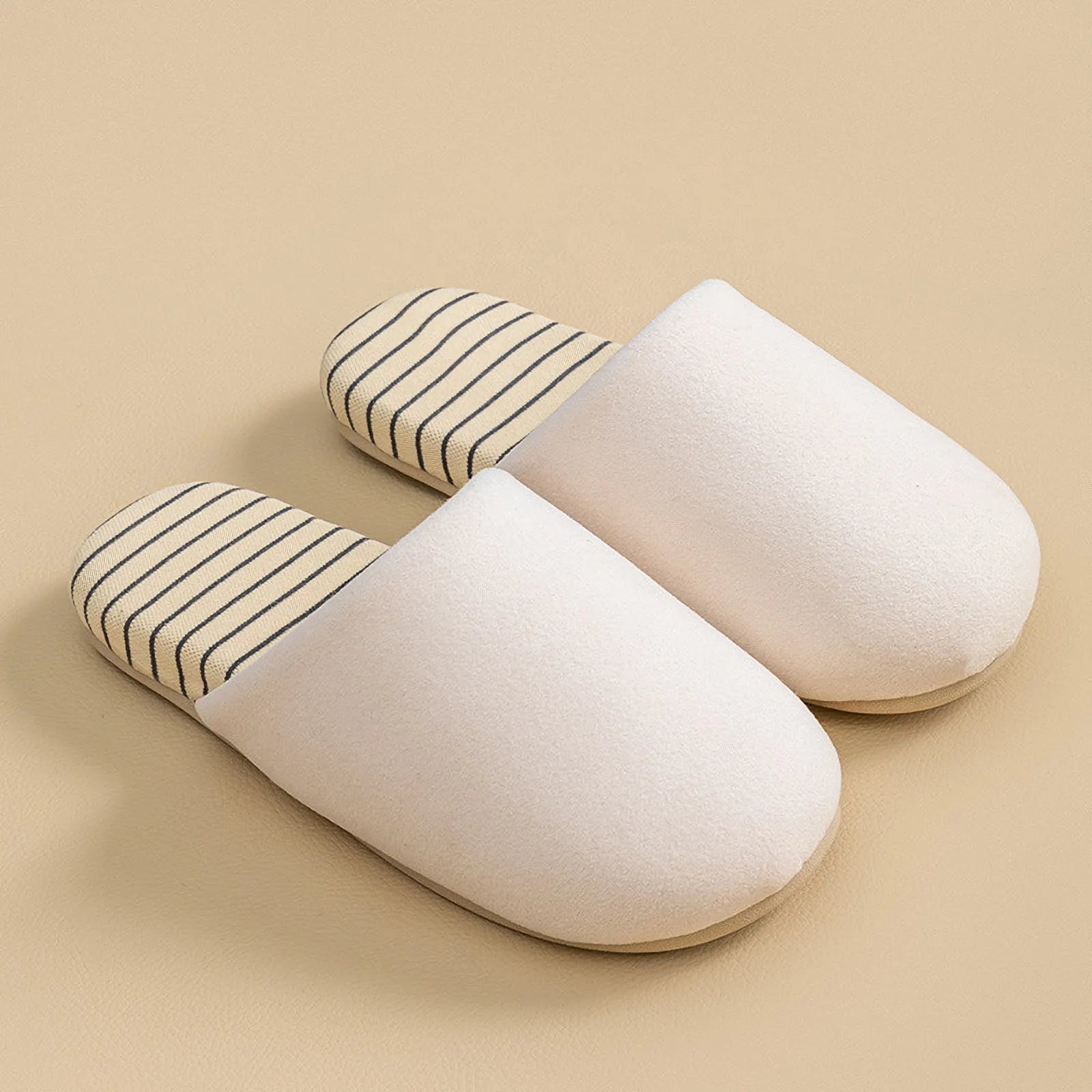 Side profile of white cotton house slipper highlighting soft flexible sole and plush lining