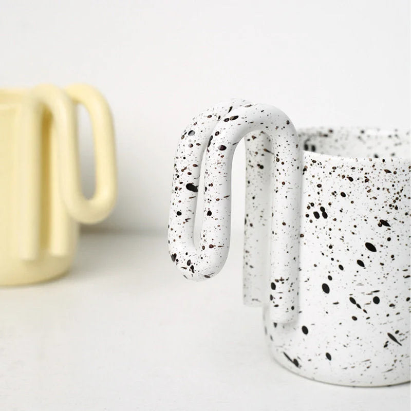 Detail shot of the white and black splatter pattern on the ceramic loop handle - RoomDen
