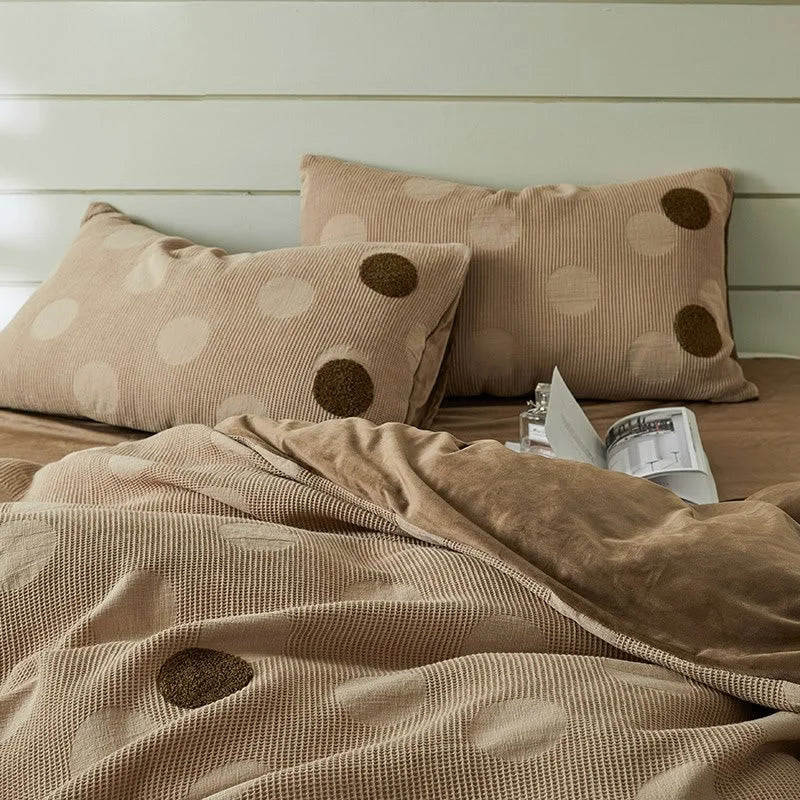 Detailed shot of the Mocha Polka Dot duvet cover and matching pillow shams on a bed. - RoomDen