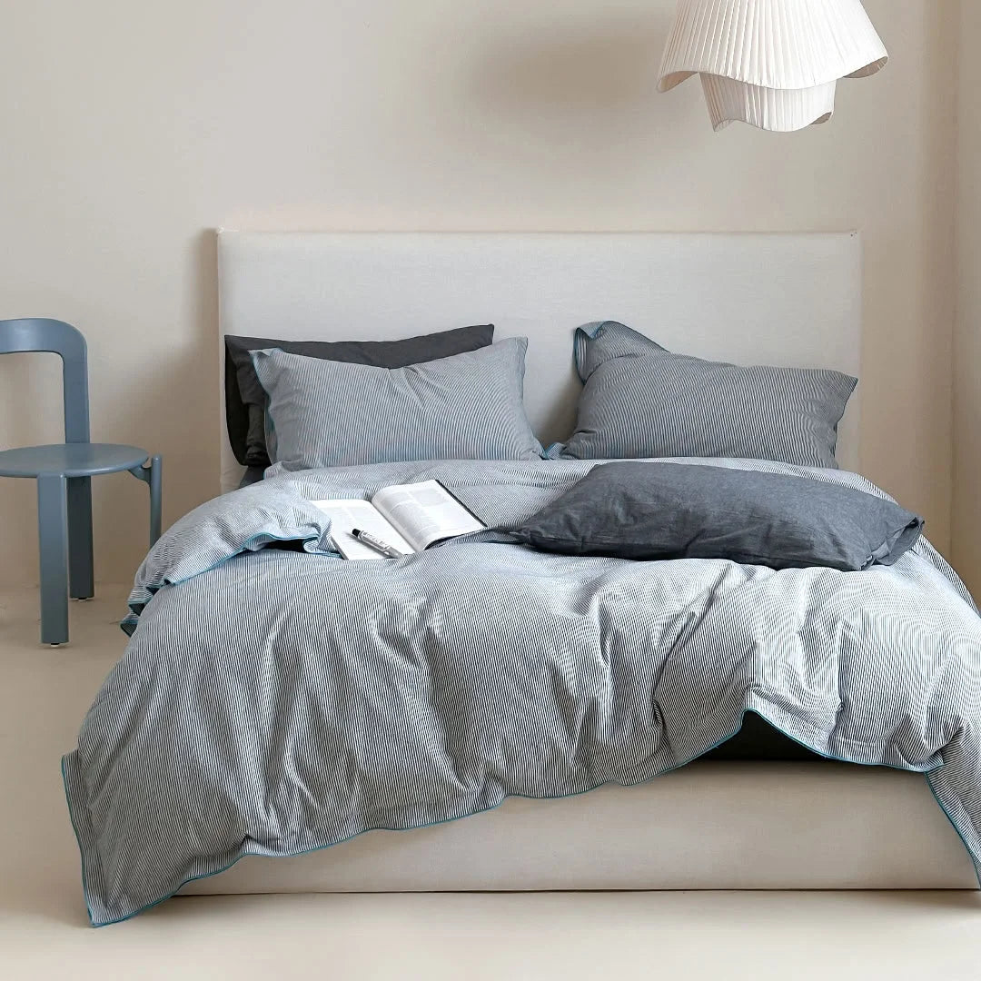 Full view of the Dark Grey & Blue Pinstripe Washed Cotton Bedding Set on a bed in a bright room - RoomDen.