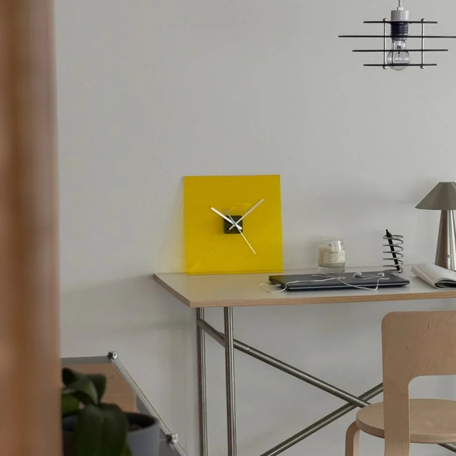 Zesty Yellow acrylic clock on a minimalist desk with a laptop and industrial-style lamp. - RoomDen