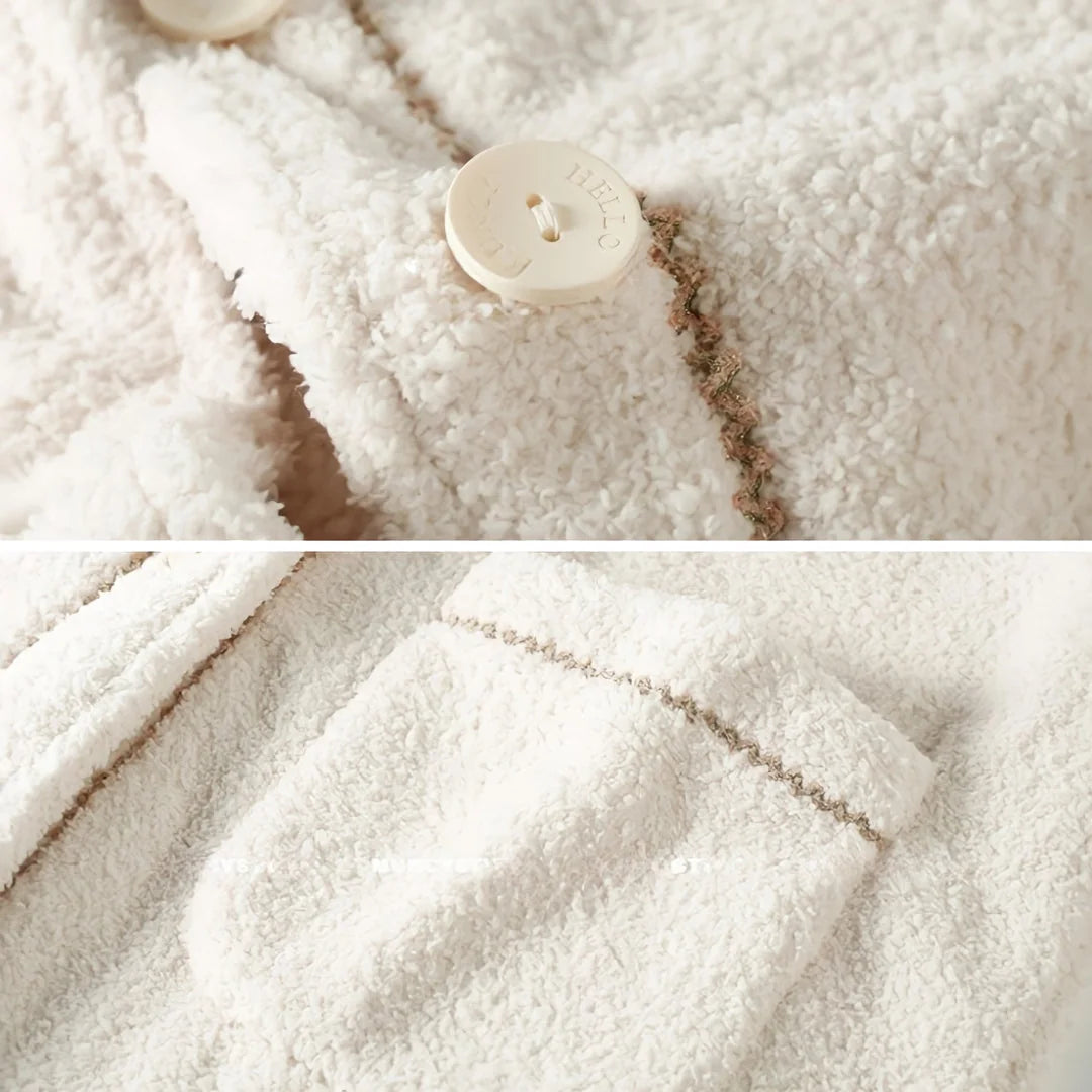 Detail shots of the creamy white fleece pajama set, showing the 'HELLO' engraved button and contrast stitching on the pocket - RoomDen.