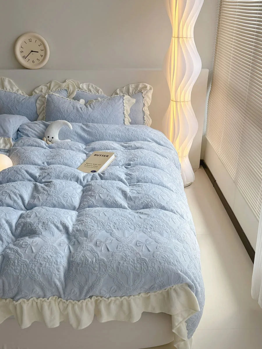 Angled view of the Powder Blue Ruffled Bedding Set next to a window with blinds, showing its texture in natural light - RoomDen.