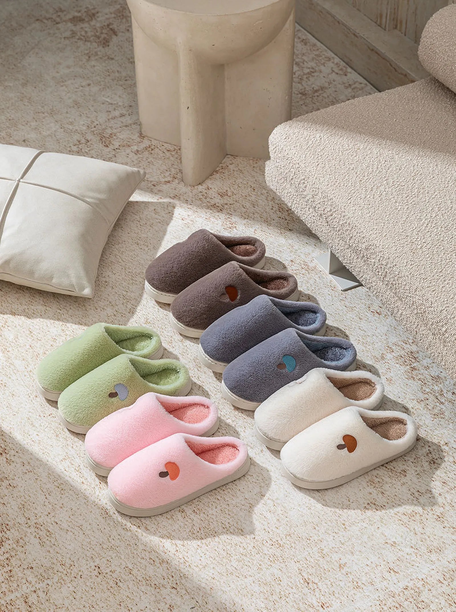 Top down view of Plush Mushroom Embroidered Fleece House Slippers collection on textured rug - RoomDen