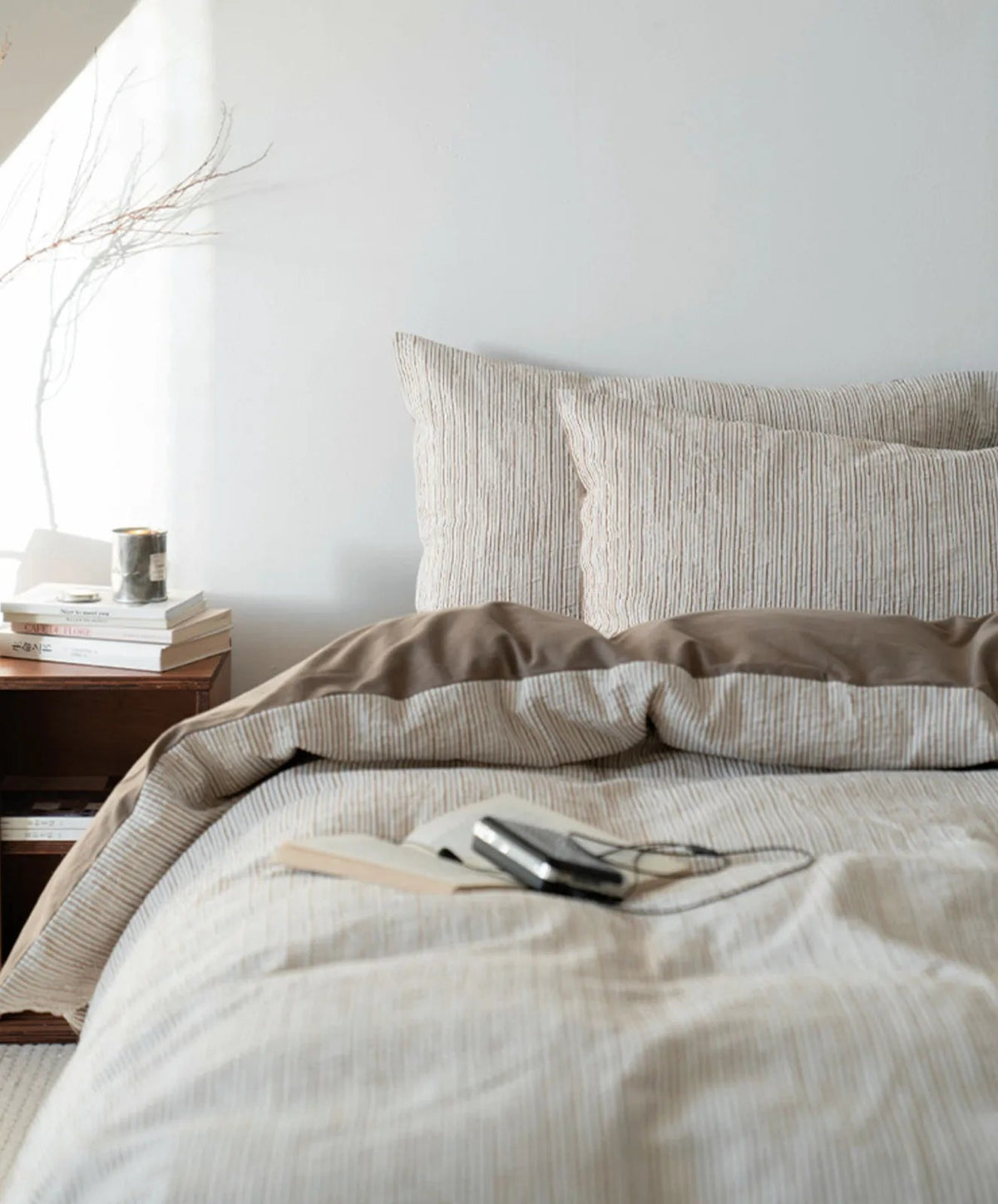 Full view of the Latte Brown pinstripe bedding set in a serene bedroom setting with natural light - RoomDen