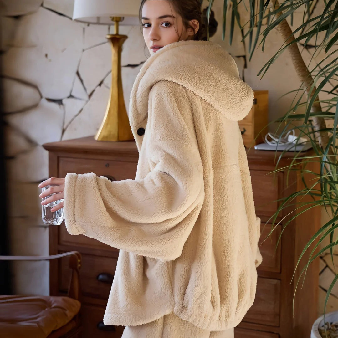 Back view of a model wearing a plush beige hooded fleece pajama set, looking over her shoulder. - RoomDen