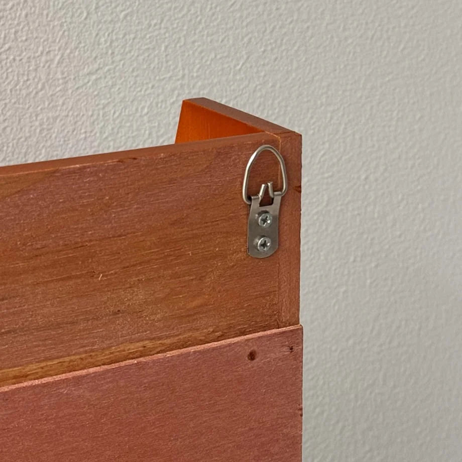 Close-up of the metal D-ring hanger on the back of the wood wall shelf for easy mounting - RoomDen