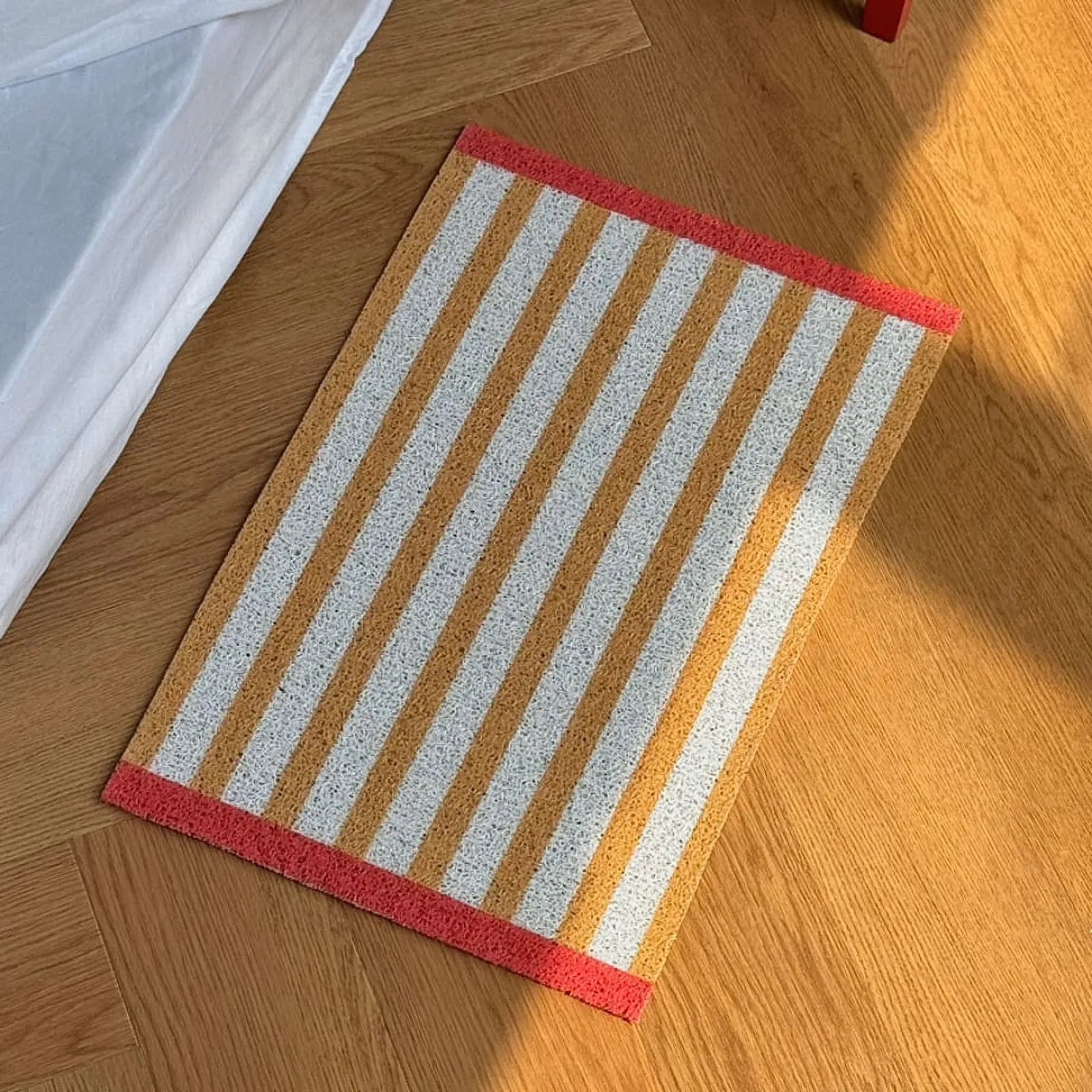 Top down view of Mustard Yellow Striped mat on wood floor - RoomDen
