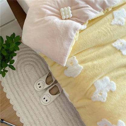 Overhead view showing the corner of the yellow teddy bear bedding, a pink pillow, and cute smiley-face slippers on a rug. - RoomDen