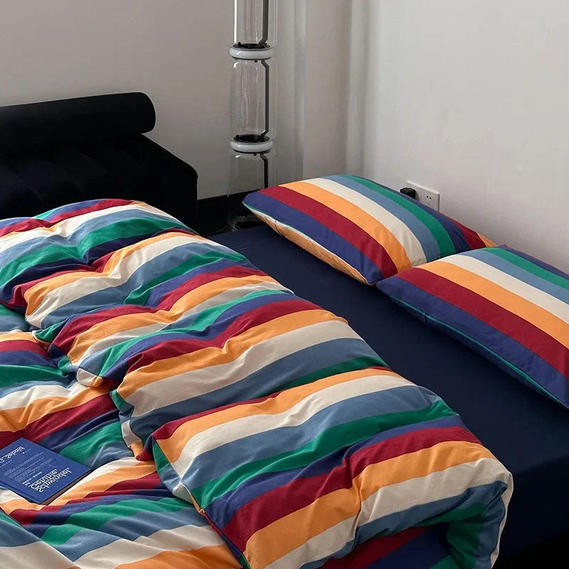 Detailed shot of the soft, wrinkled texture of the rainbow striped washed cotton duvet and pillowcases - RoomDen