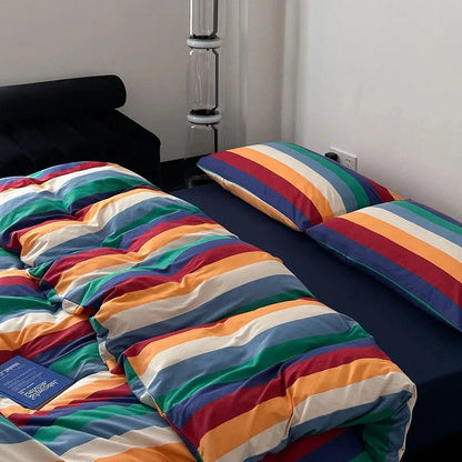 Detailed shot of the soft, wrinkled texture of the rainbow striped washed cotton duvet and pillowcases - RoomDen