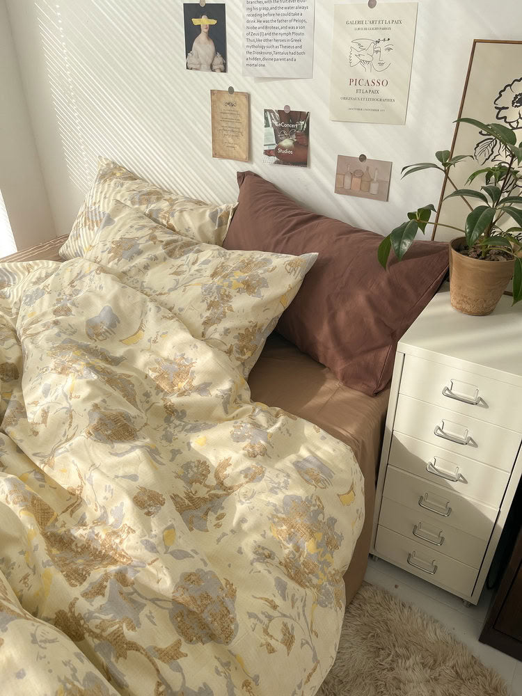 Detail of beige abstract floral bedding near window with natural light and textured cotton fabric - RoomDen