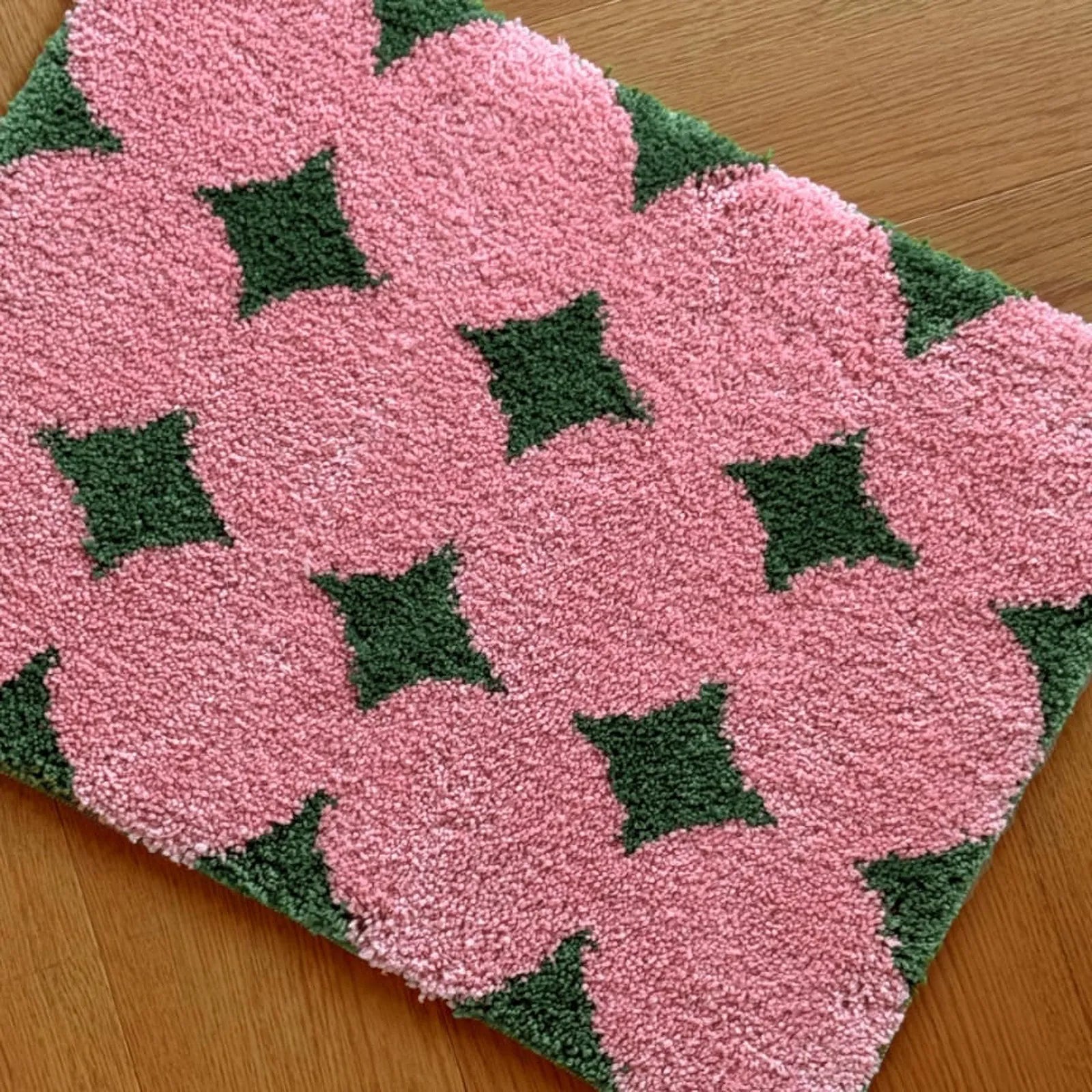 Close up texture detail of pink flower pattern rug - RoomDen