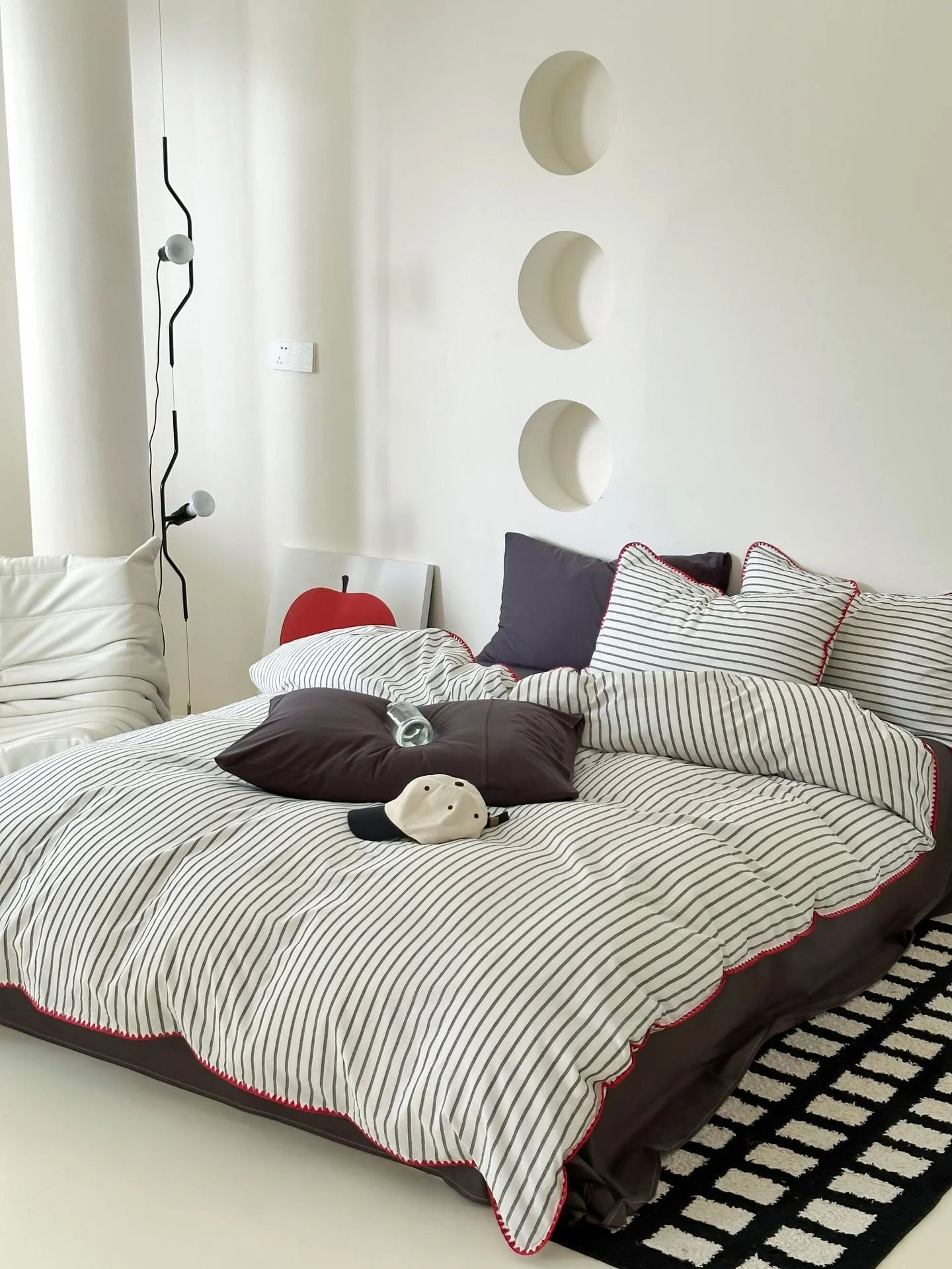 Close up of Black Striped Pillowcase with Red Embroidery Detail - RoomDen