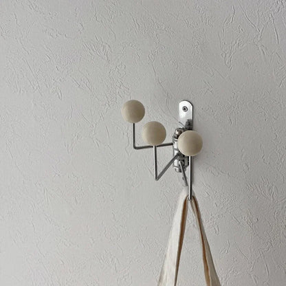 Angled view of the cream triple-arm swivel hook, highlighting its minimalist design - RoomDen.