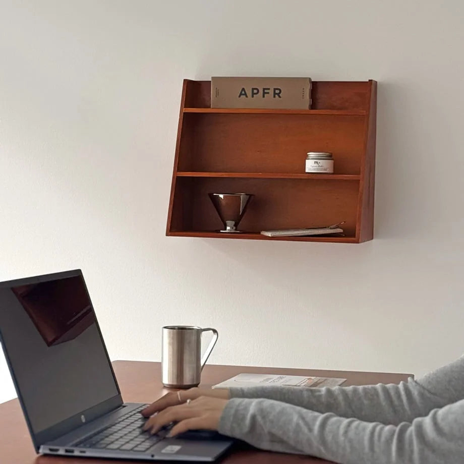 Natural grain slanted wood wall shelf above a calm japandi-style desk at first light - RoomDen