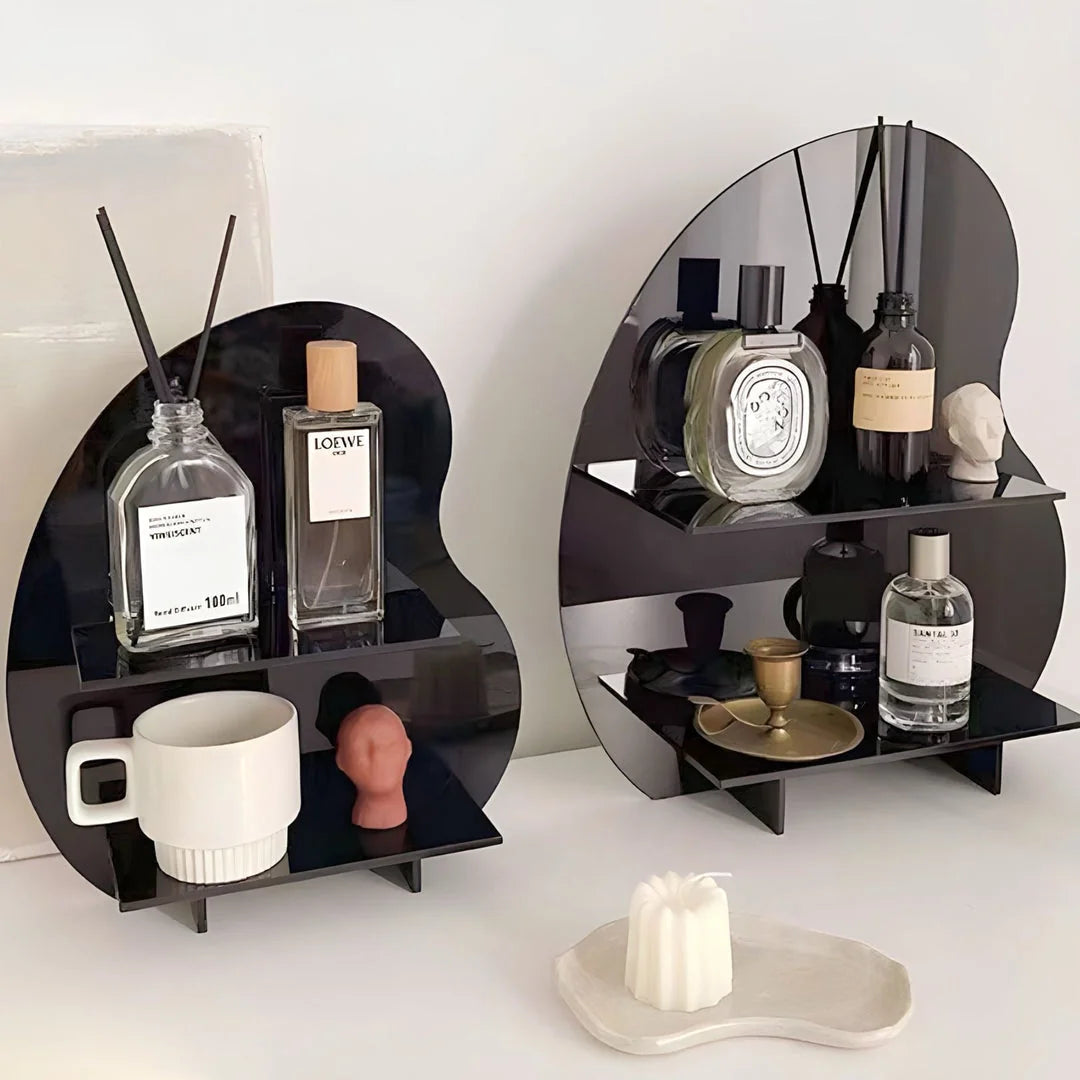 Close-up of two black abstract wavy acrylic organizers showing their glossy finish and storage capacity. - RoomDen