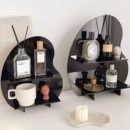 Close-up of two black abstract wavy acrylic organizers showing their glossy finish and storage capacity. - RoomDen