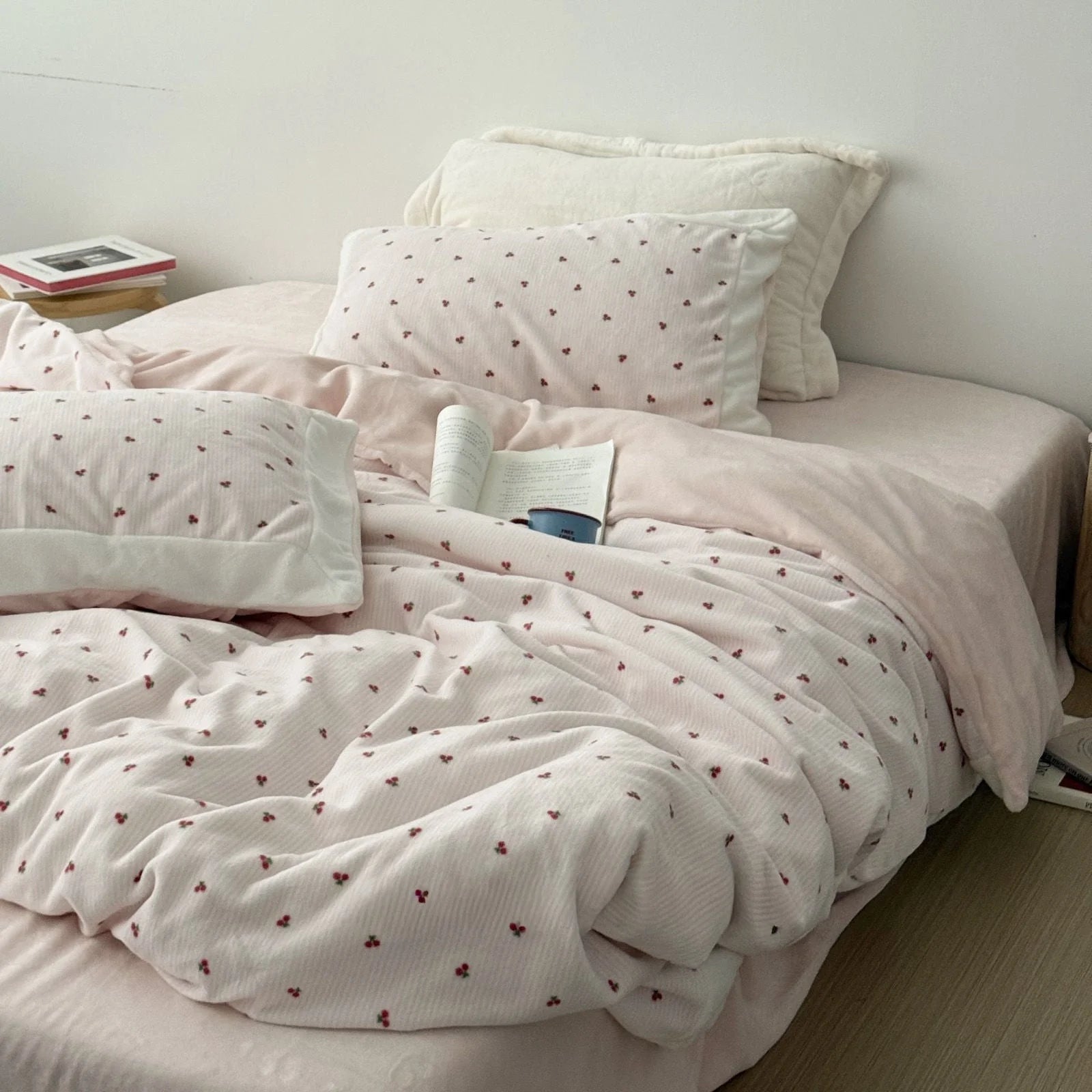 Lifestyle image of the blush pink cherry bedding set in a bright, minimalist bedroom setting. - RoomDen