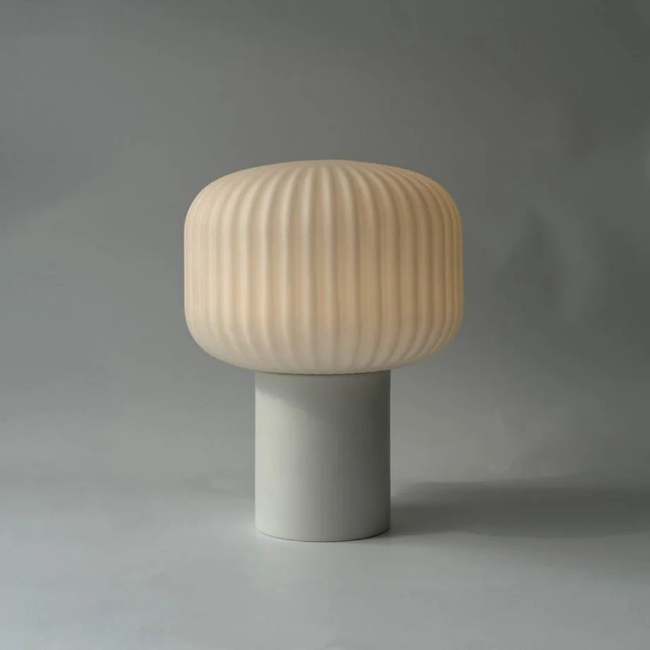 Studio product shot of the Pleated Glass Mushroom Accent Lamp illuminated against a grey background - RoomDen