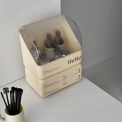 Angled view of the cream typographic makeup organizer, showing the transparent ribbed flip-top lid.