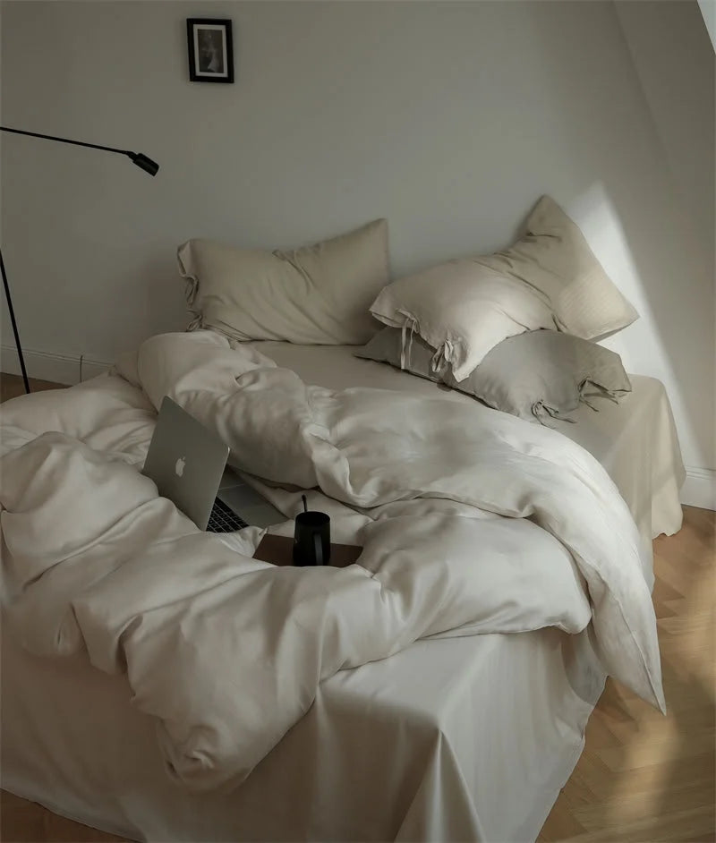 Silky Soft Tie Closure Tencel Bedding Set in Oatmeal Beige with a laptop on the bed - RoomDen
