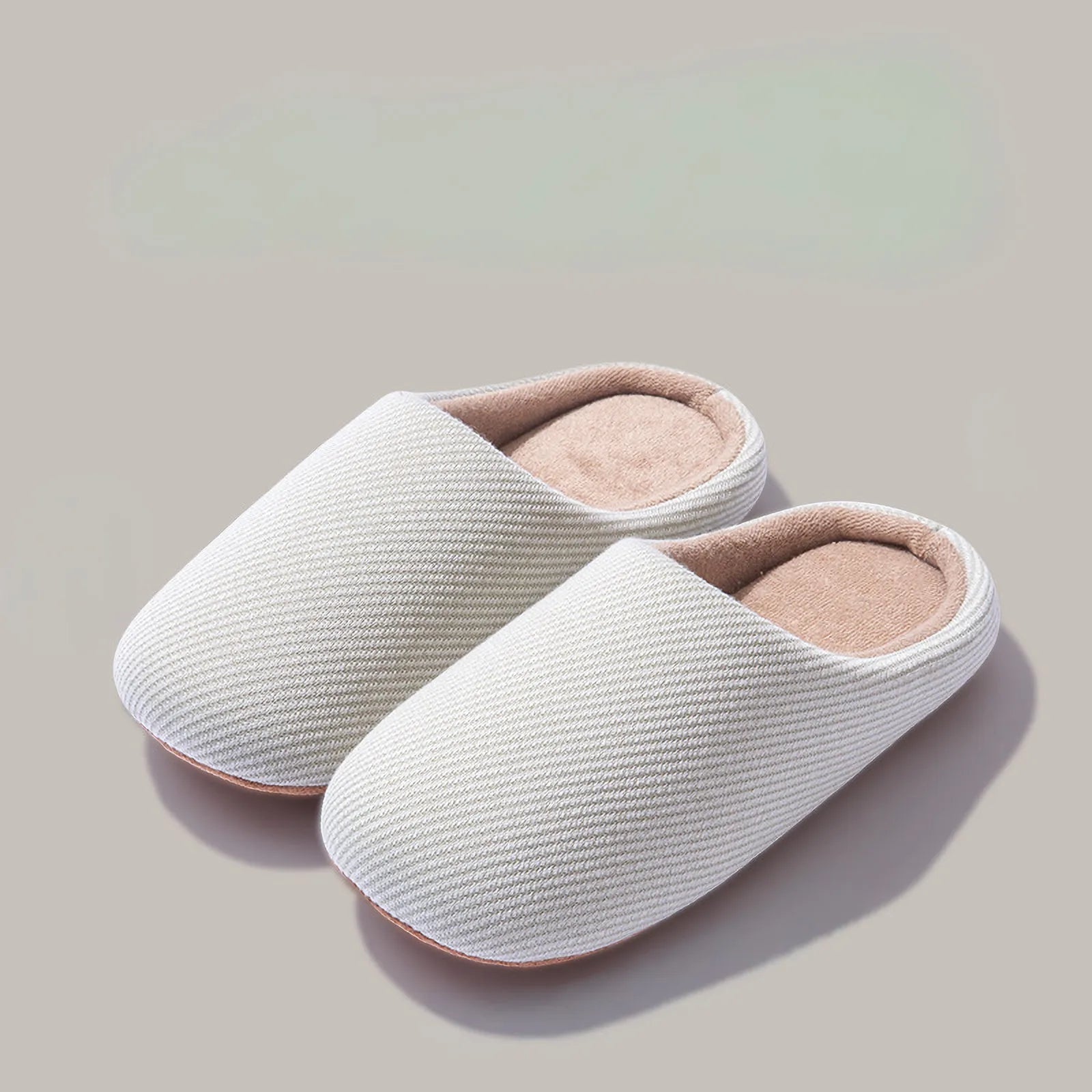 Pair of white ribbed cotton house slippers isolated roomden