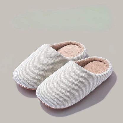 Pair of white ribbed cotton house slippers isolated roomden