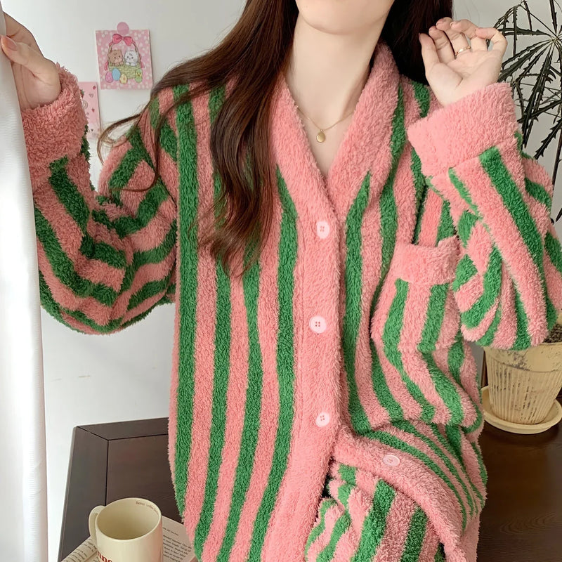 Close-up of the plush fleece texture and pink buttons on the bold striped pajama top - RoomDen