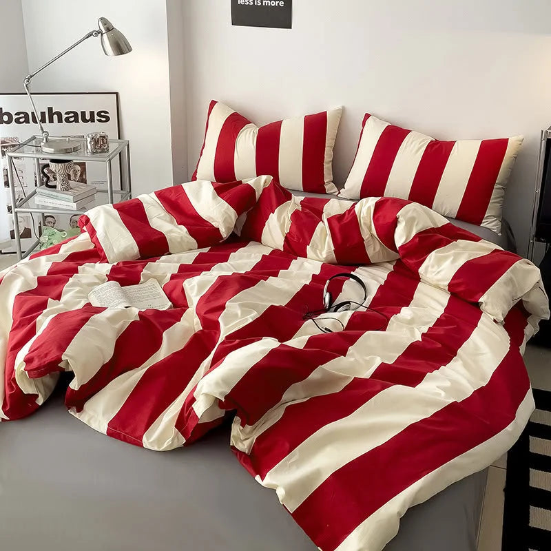 Full view of the Red & Cream Striped Bedding Set in a bright, modern bedroom with a 'bauhaus' poster - RoomDen